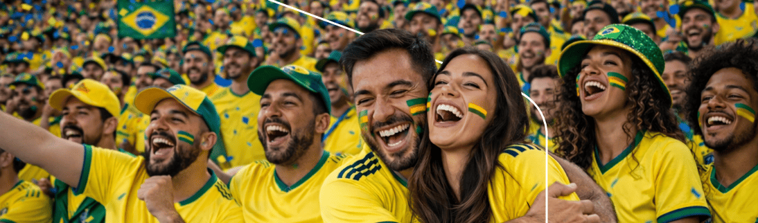 Casal e multidão de torcedores brasileiros comemorando em meio a confetes nas arquibancadas de um estádio.