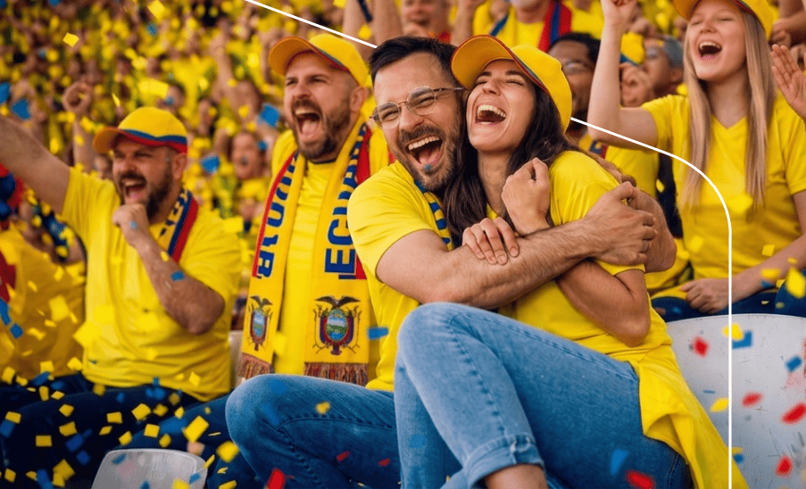 Paquetes Pareja y multitud de aficionados ecuatorianos celebrando entre confeti en las gradas de un estadio.